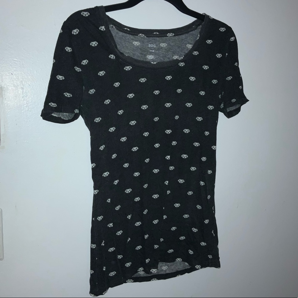 Black shirt with puppies designed on it.